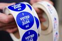 A poll worker holds voting stickers for community members Nov. 7, 2023, at Central Elementary School in Allentown, Lehigh County, Pennsylvania.