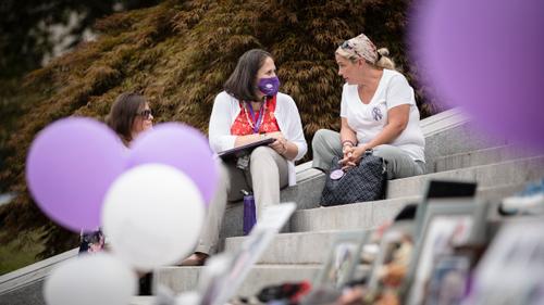 Susan Ousterman speaks to the Department of Drug and Alcohol Programs secretary, Jennifer Smith, during an overdose awareness event at the state Capitol in Harrisburg on Aug. 31, 2021.