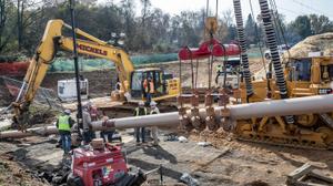 Pipefitters, left, work to connect a long segment of pipe that is being suspended in air to make it ready to be pulled undergroud in a residential area of West Chester, PA on Ship Road and South Pullman Drive as part of the Mariner East Pipeline that is going through the area on November 11, 2019.