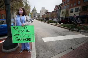 Nurse Erica Zimmerman, of southwestern Pennsylvania, urges protesters who gathered outside the Capitol Complex to go home during a rally in Harrisburg, PA on April 20, 2020. The protesters are calling for Gov. Wolf to reopen up the state's economy during the coronavirus outbreak. Nurse Erica Zimmerman, of southwestern Pennsylvania, urges protesters who gathered outside the Capitol Complex to go home during a rally in Harrisburg, PA on April 20, 2020. The protesters are calling for Gov. Wolf to reopen up the state's economy during the coronavirus outbreak.
