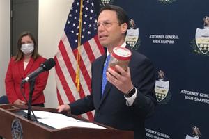 Pennsylvania Attorney General Josh Shapiro, right, holds a jar of discolored tap water during a news conference. He said the sample was from the home of a state resident whose well had been tainted by nearby natural gas drilling. Pennsylvania Attorney General Josh Shapiro, right, holds a jar of discolored tap water during a news conference. He said the sample was from the home of a state resident whose well had been tainted by nearby natural gas drilling.