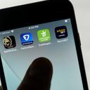 FanDuel, DraftKings, and other online gambling apps are displayed on a phone.