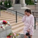Leah Palmer visits a makeshift memorial for Minnesota state Rep. Melissa Hortman and her husband Mark in St. Paul.