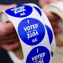 A poll worker holds voting stickers for community members Nov. 7, 2023, at Central Elementary School in Allentown, Lehigh County, Pennsylvania.