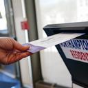 A voter puts a ballot into a drop box on primary Election Day 2024 at Bethlehem City Hall in Northampton County, Pennsylvania.
