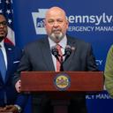 Democratic congressional candidate Bob Brooks stands at a podium.