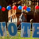 Students on the campus of the University of Pittsburgh walk past a ‘vote’ sign on Election Day, Nov. 5., 2024.