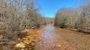 A stream along Coaldale Road in Rush Township, Centre County, runs orange from acid mine drainage.