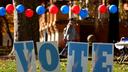 Students on the campus of the University of Pittsburgh walk past a ‘vote’ sign on Election Day, Nov. 5., 2024.