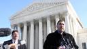 Citizens United President David Bossie (right) meets with reporters outside the U.S. Supreme Court.