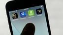 FanDuel, DraftKings, and other online gambling apps are displayed on a phone.