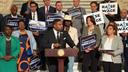 Rep. Jason Dawkins (center) speaks at a new conference urging the PA Senate to raise the minimum wage.