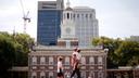 People move past Independence Hall at the Independence National Historical Park in Philadelphia, Aug. 25, 2016.