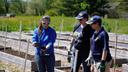 Garden of Health founder Carol Bauer and two other people at a farm.