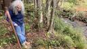Bradford resident and retiree Barbara Laxon stands next to an abandoned, uncapped oil well.