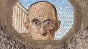 A Jim Bachor pothole mosaic in Chicago inspired by Grant Wood's American Gothic painting.