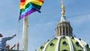 The Pride Flag is raised on a flagpole at the state Capitol building in Harrisburg.
