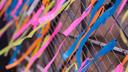 Ribbons tied to a fence as part of an art installation remembering lost loved ones in Philadelphia.