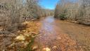 A stream along Coaldale Road in Rush Township, Centre County, runs orange from acid mine drainage.