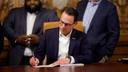 Gov. Josh Shapiro signs the final pieces of the 2023 Pennsylvania budget in the Capitol.