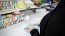 A pharmacy worker prepares a prescription.