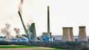 The smokestacks of the former coal-fired Homer City Generating Station crumble in a planned demolition in Homer City, Pa.