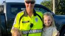 Crossing guard Jan Weaver hugs two children