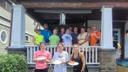 Mayor Michele Bannon (third from right in top row) poses with Group Mission Trips volunteers at a small home repairs project in Carbondale.