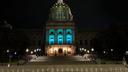 The Pennsylvania Capitol building illuminated in teal for Sexual Assault Awareness Month.