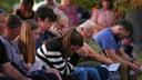 Attendees react during a vigil in Spring Grove, PA, after multiple police officers were shot and killed.