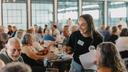 Spotlight PA Rural Affairs Reporter Marley Parish collects quiz sheets at the 2024 Clink and Think Quiz Bash Fundraiser at Axemann Brewery in Bellefonte.