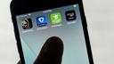 FanDuel, DraftKings, and other online gambling apps are displayed on a phone.