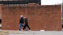 People walk past locations of the now removed explanatory panels that were part of an exhibit on slavery.