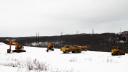 A high-voltage powerline runs behind a construction site in Archbald, PA.