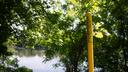 A pipeline marker along a riverbank.