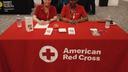 Red Cross volunteer Mary Harper (right) sits at a table