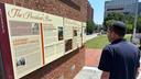 Visitors view the reinstalled educational panels about slavery at the site of President George Washington's home in Philadelphia, Wednesday, July 15, 2026.