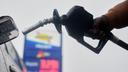 A motorist removes the pump from his car at a gas station, in Philadelphia, Tuesday, March 3, 2026.