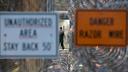 Barbed wire and warning signs at a Pennsylvania prison.