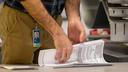 A worker preparing 2022 ballots in Philadelphia. A new bill would give counties more time to prep these ballots.