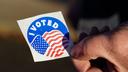 A voter holds an “I Voted” sticker Nov. 8, 2022, at Memorial Hall in Jim Thorpe Carbon County, Pennsylvania.