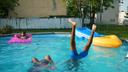 Quadrice Quarles, back left, 11 years old, Kayla Melvin, front left, 9 years old, and .Quadir Staton, front right, 10 years old,.Swim in a pool, in North Philadelphia, July 16, 2019.