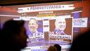 Early results for the governor’s race appear on screen at Doug Mastriano’s election night watch party in Camp Hill, PA.