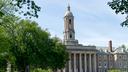 People walk across Old Main lawn on the Penn State campus on Wednesday, May 19, 2021.