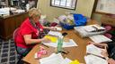 Marcie Strachko, Columbia County’s human resources director, processes mail ballots during the 2023 municipal primary.
