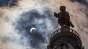 The statue of William Penn atop Philadelphia's City Hall is silhouetted by the partial solar eclipse in 2017.