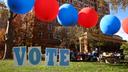 Students on the campus of the University of Pittsburgh walk past a ‘vote’ sign on Election Day, Nov. 5., 2024.