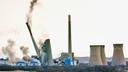 The smokestacks of the former coal-fired Homer City Generating Station crumble in a planned demolition to make way for a new natural gas-fired power plant.