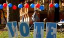 Students on the campus of the University of Pittsburgh walk past a ‘vote’ sign on Election Day, Nov. 5., 2024.