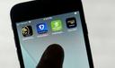 FanDuel, DraftKings, and other online gambling apps are displayed on a phone.
